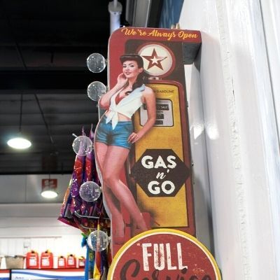 Vintage gas sign hanging in top convenience store near Campanil, Santa Barbara CA.