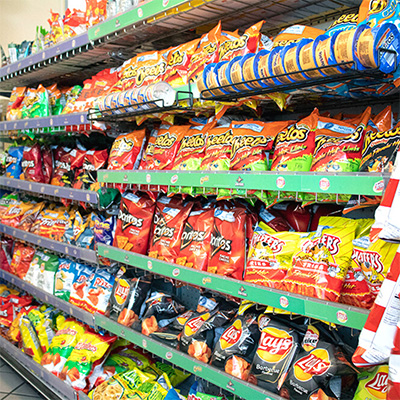 Shelves with Doritos, Lays, Cheetos, and other Hobson Park East snacks available at our Convenience Store.