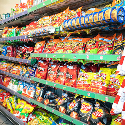 Shelves with Doritos, Lays, Cheetos, and other Riverpark snacks available at our Convenience Store.