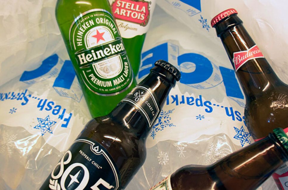 A close up of beer bottles on bags of ice, sold at our beer store near West Village, Oxnard, California.