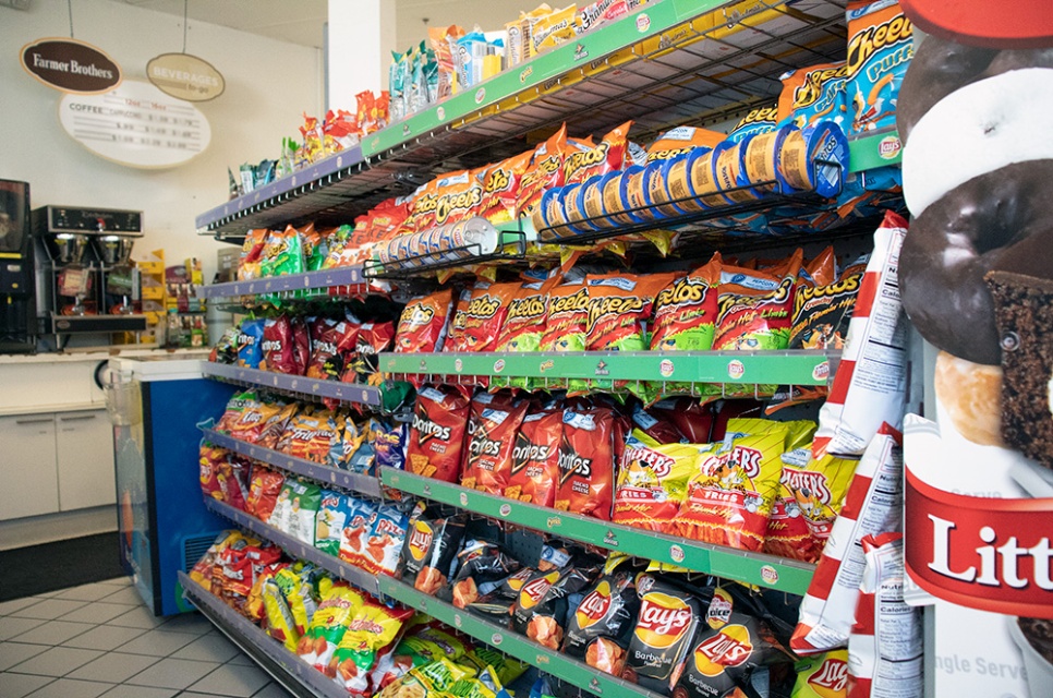 Convenience Store shelf filled with different types of chips, some of our quick snacks near Strickland, Oxnard, California.
